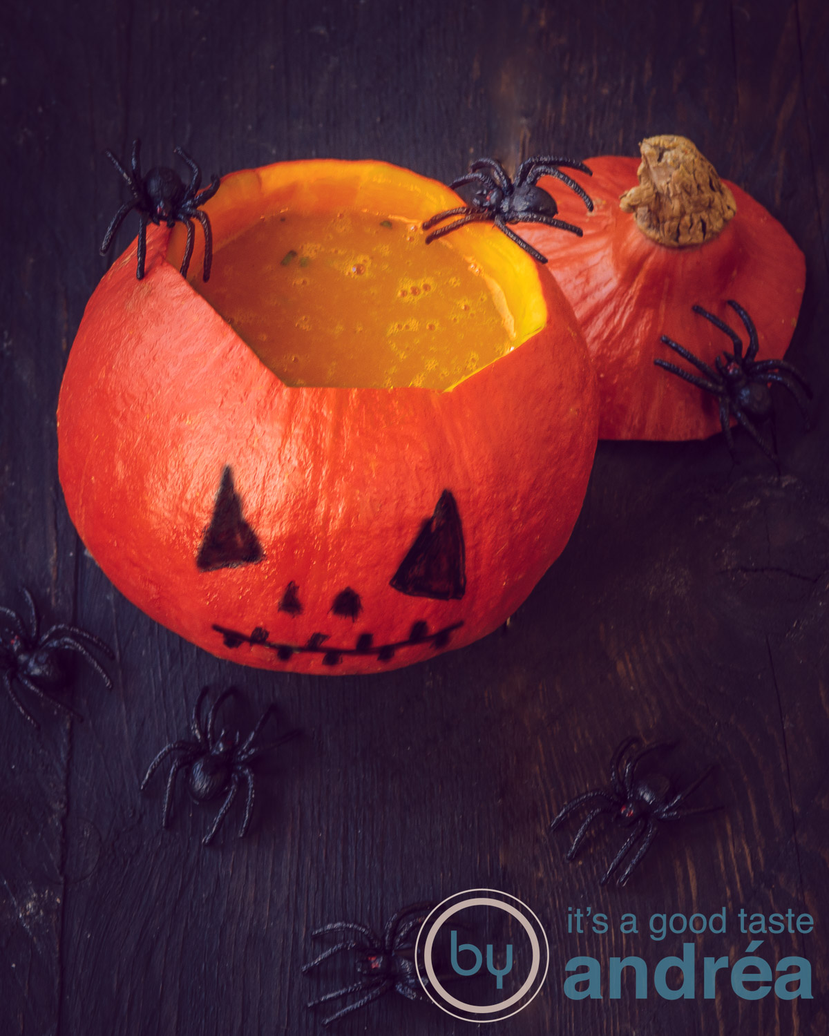 Pumpkin soup served in a pumpkin which got a Jack-O-lantern face. With additional spiders