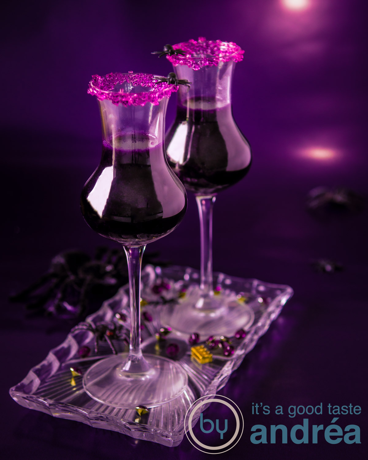 Halloween witch potion, two pink cocktails on a glass plate. A pink background