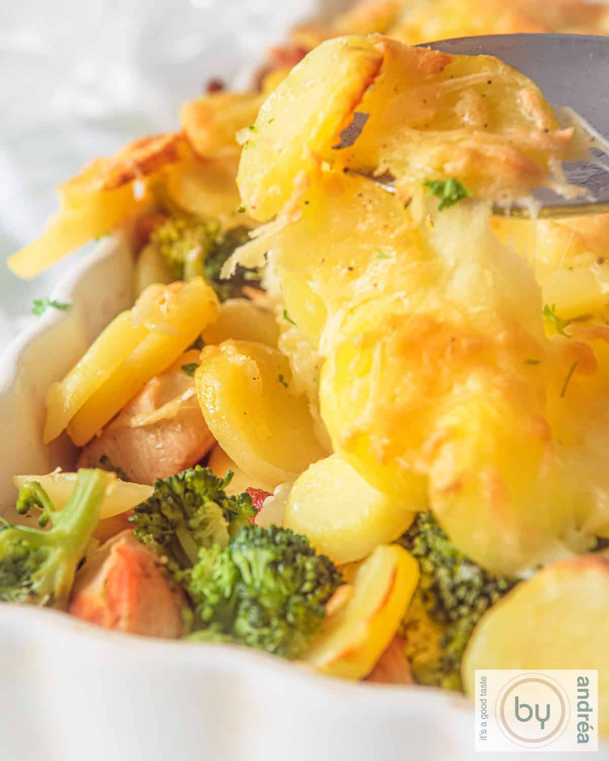 Chicken, bacon, broccoli and potato casserole in a white casserole dish