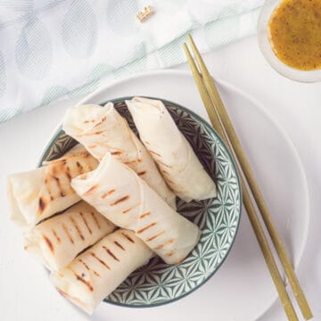 a bowl with cheese and cauliflower lumpia's. A small bowl with some dill honey mustard in the corner