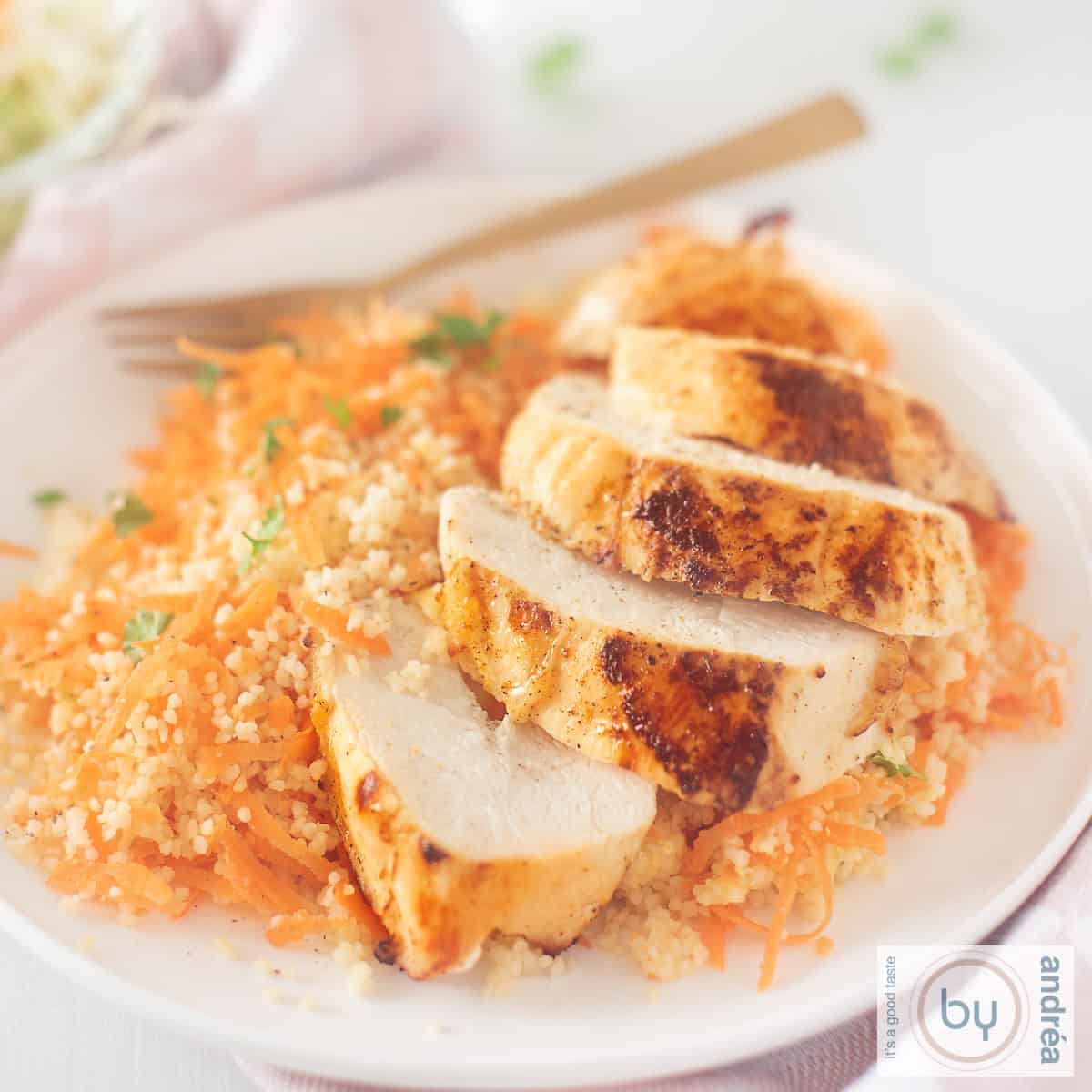 A square photo with Ras El Hanout chicken with spicy carrot couscous