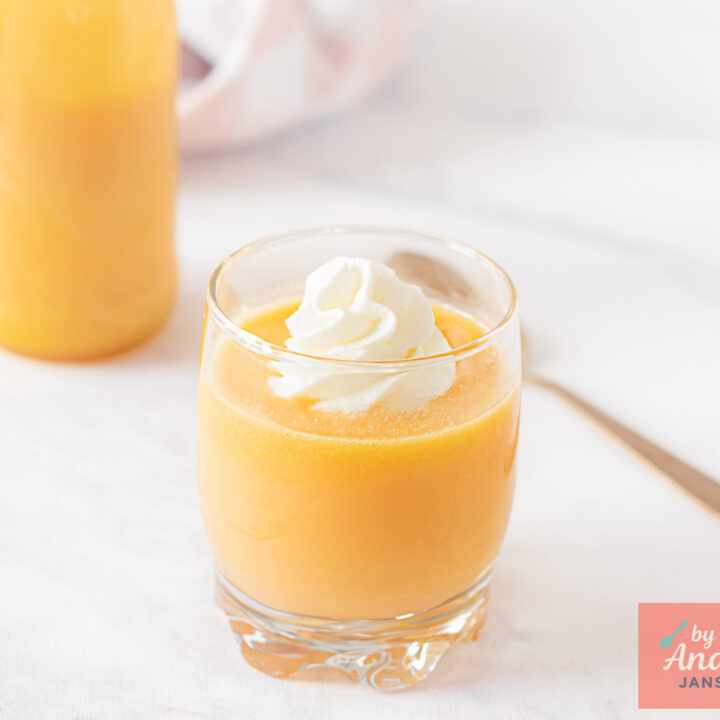 Bottle of homemade advocaat next to a filled glass