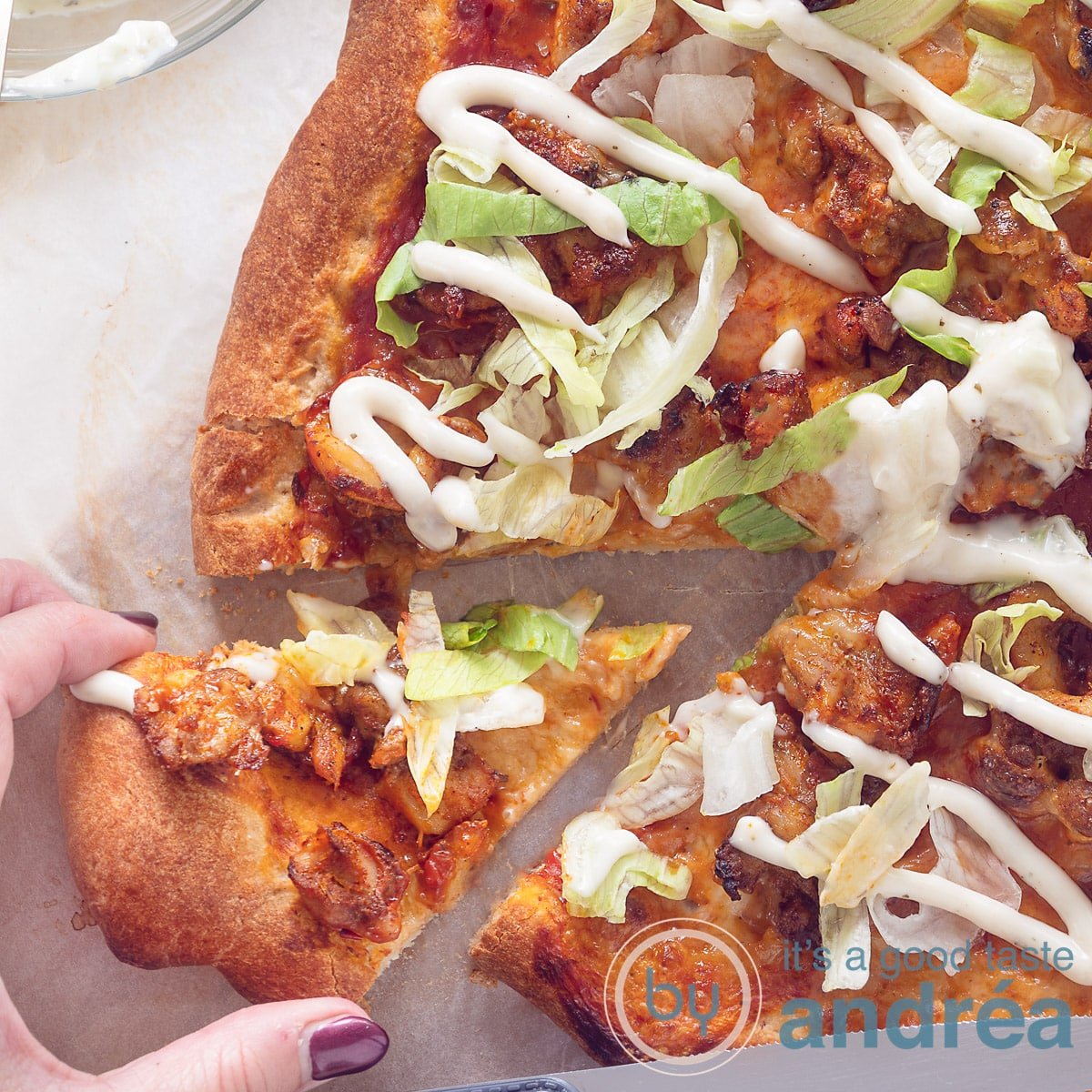 A square photo with a slice of a kebab pizza. Cut out a slice that is taken out.