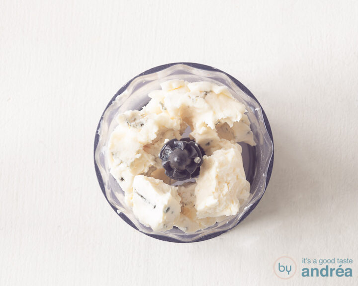 A blender bowl with gorgonzola cheese