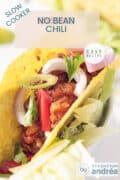 A taco filled with chili con carne no beans and some veggies. A text on top: slow cooker, no bean chili, easy recipe