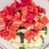 A bowl with diced sweet point pepper and zucchini