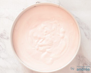 A springform pan filled with strawberry cottage cheese.
