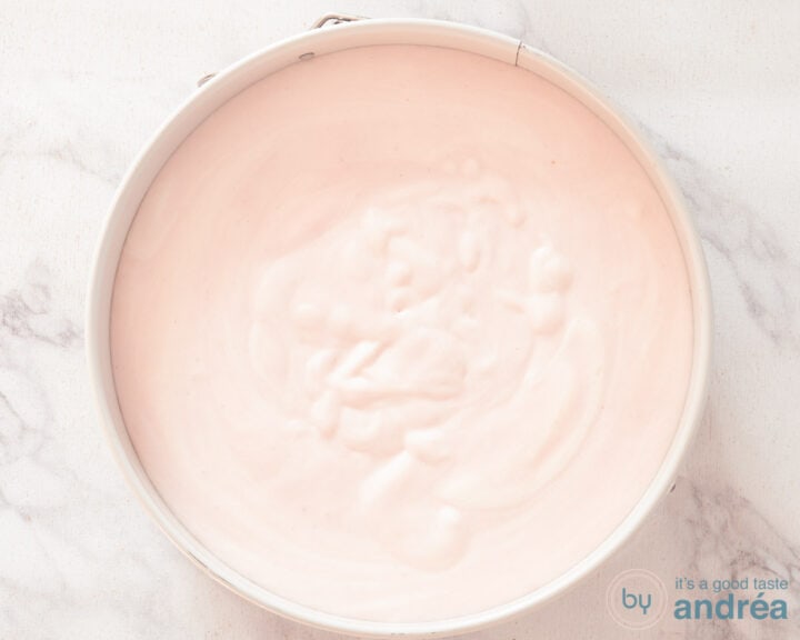 A springform pan filled with strawberry cottage cheese.