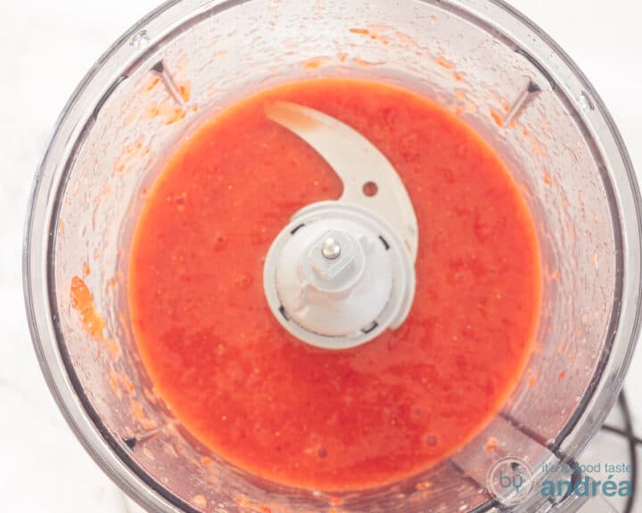 Strawberries are finely ground in the food processor into juice.
