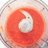 Strawberries are finely ground in the food processor into juice.
