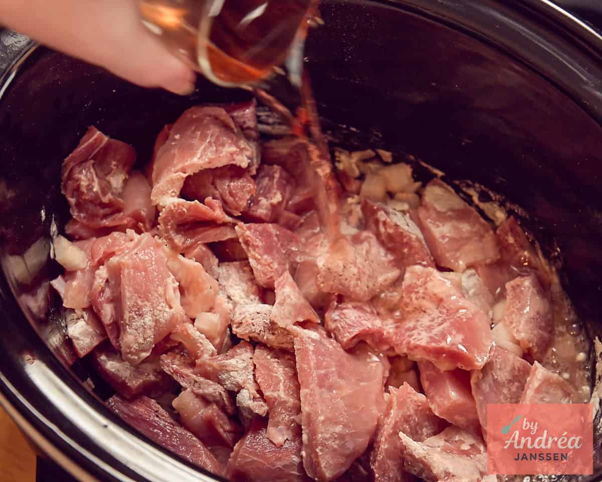 Pour rose wine into the slow cooker.