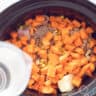 Water is added to the ingredients in the slow cooker.