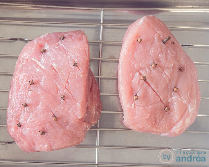 Notches are made in the ham, diagonally, and a clove is inserted at the intersections. The fl