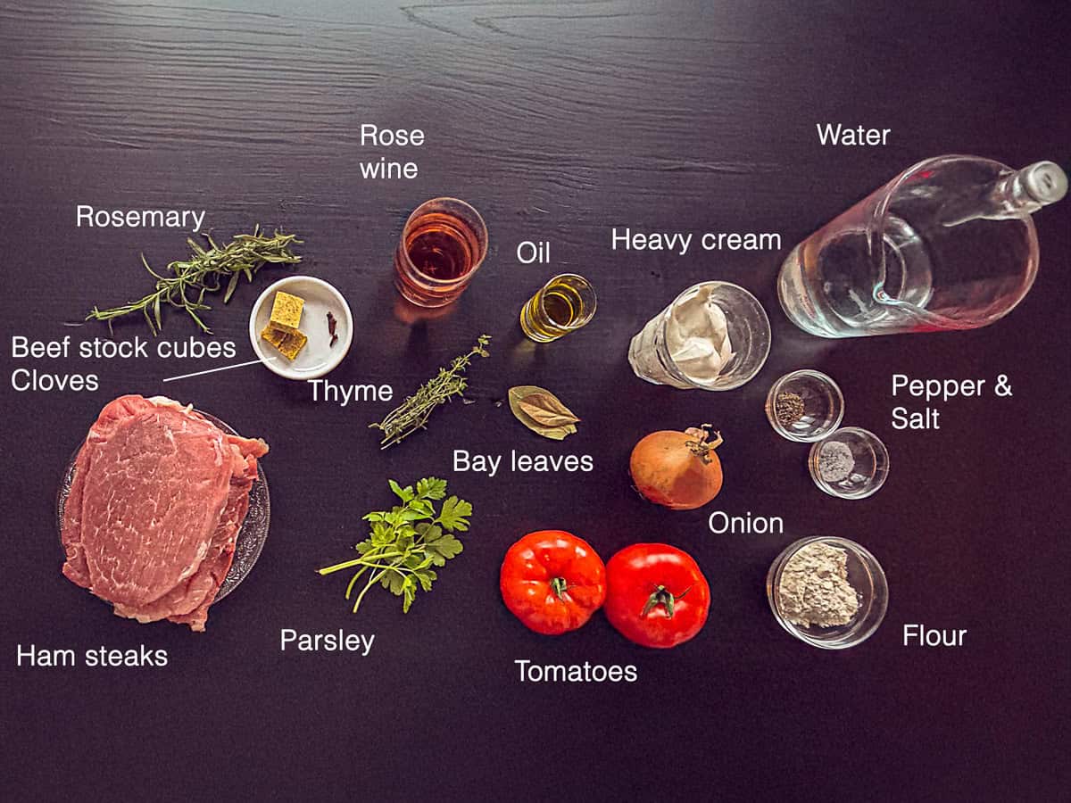 Ingredients Slow Cooker French Ham Steak Stew on a black background with text description