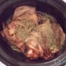 Roast beef in the slow cooker wrapped in bacon and sprinkled with rosemary and thyme.