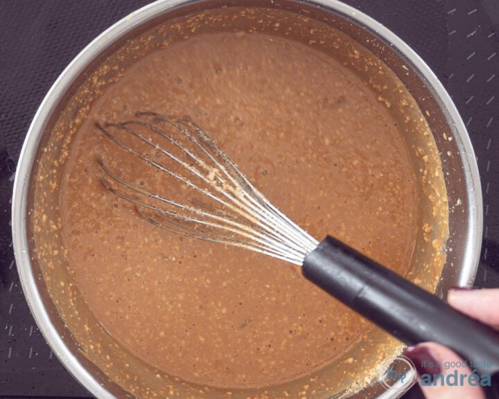A saucepan in which nuts, milk, and other ingredients have been stirred together.