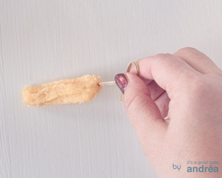 A churro in which a hole is made with a skewer so that it can be filled.
