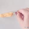 A churro in which a hole is made with a skewer so that it can be filled.