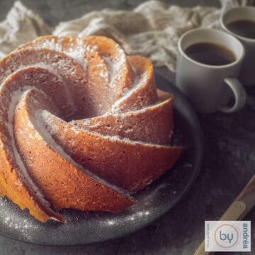 A square photo with part of a pumpkin turban with a cup of coffee