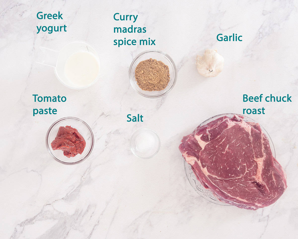 Ingredients curry madras marinade on a white marble background with a text description