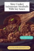 A portion of a slow cooker filled with Indonesian meatballs. A text: Slow Cooker Indonesian Meatballs With Soy Sauce