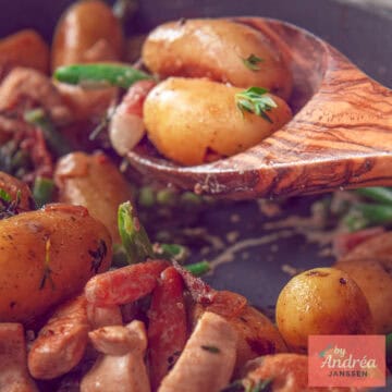 A square photo of a wooden spoon with potatoes, vegetables and chicken