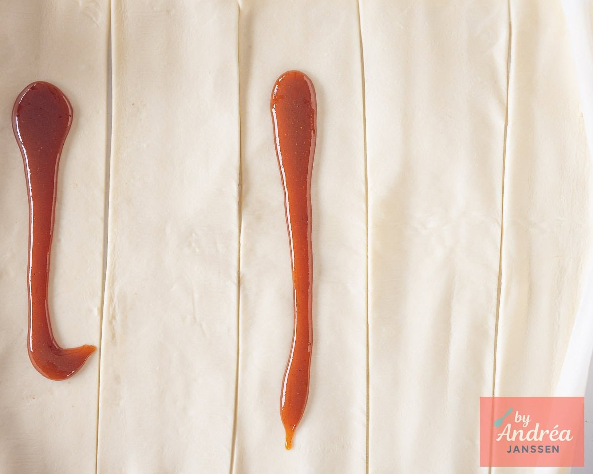 Puff pastry cut into strips with curry on top.