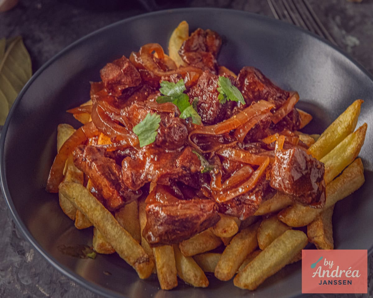 A gray plate with fries and stew: fries and stew