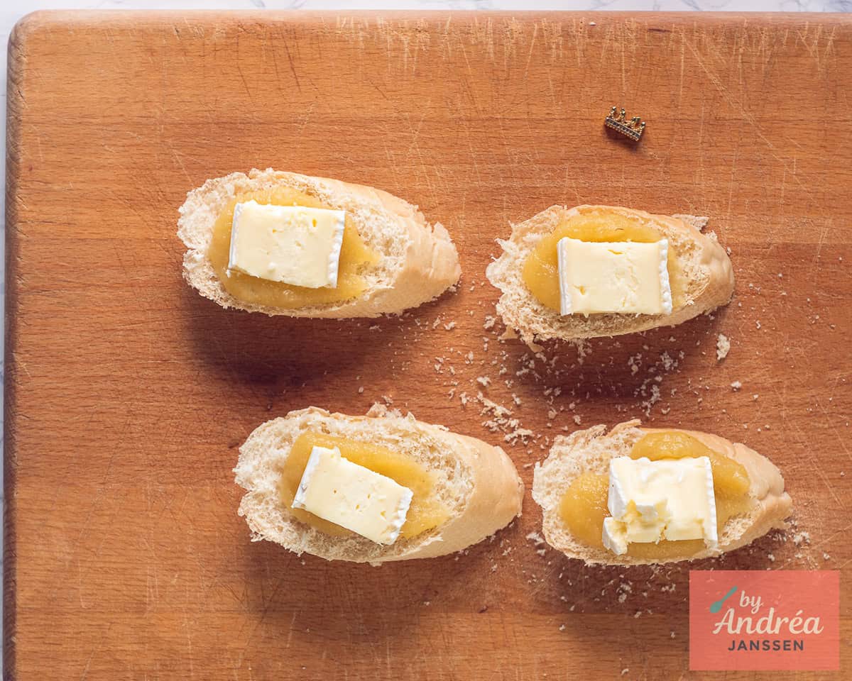 Brie is placed on slices of baguette with apple sauce