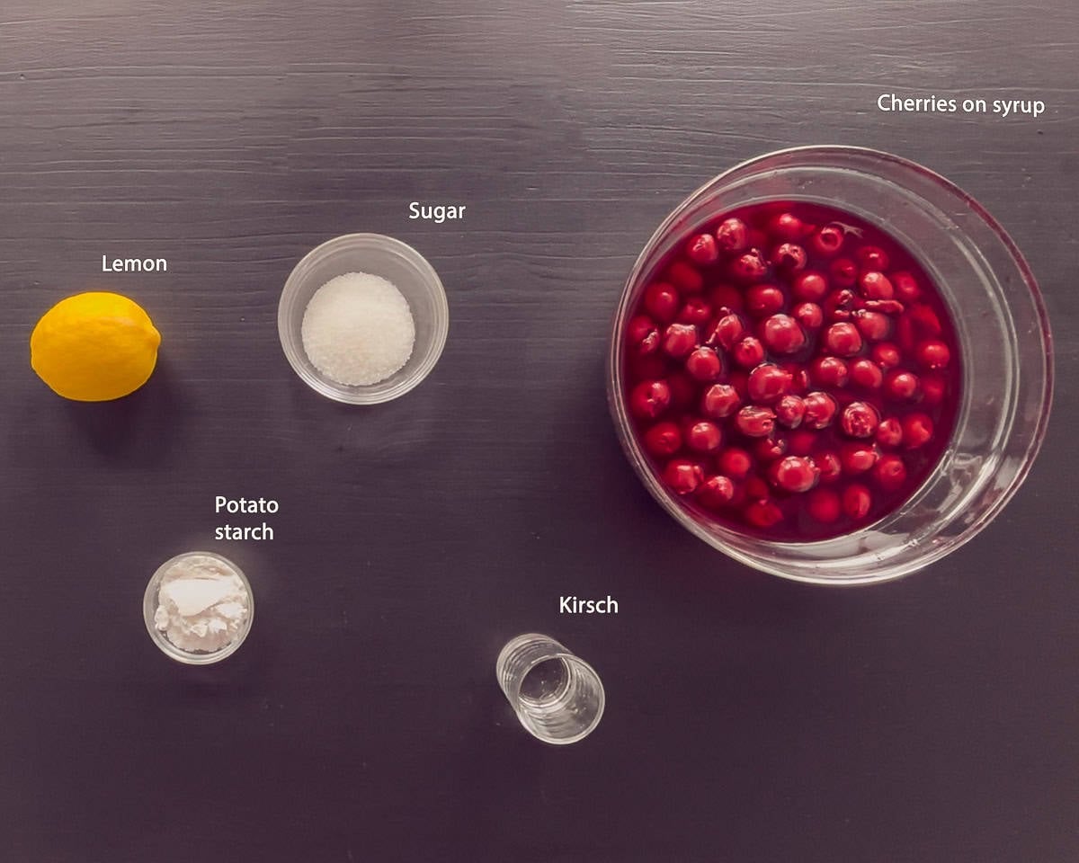 ingredients for Dutch Kersenvlaaivulling cherry pie filling on a black background with text description