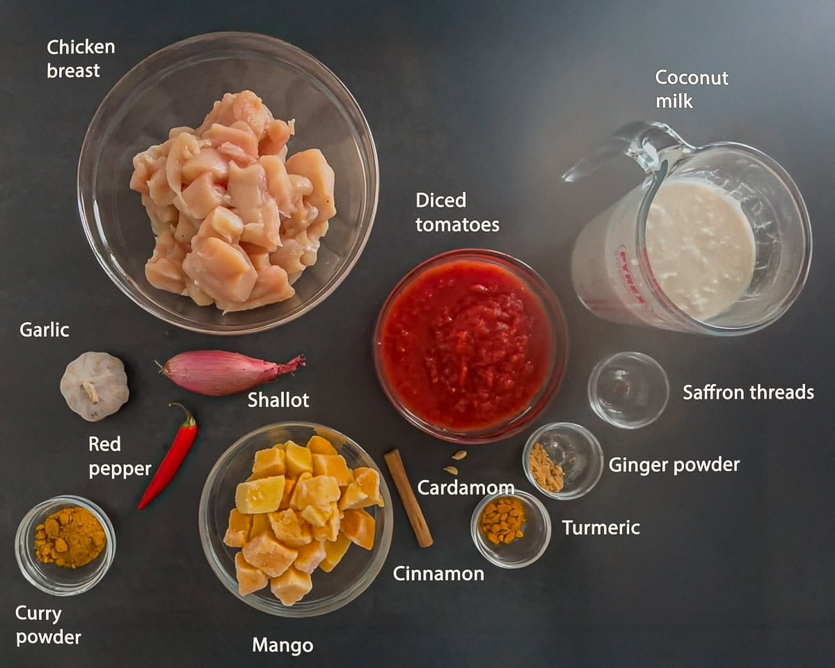 Ingredients Slow Cooker Chicken Curry With Mango on a black background with text description