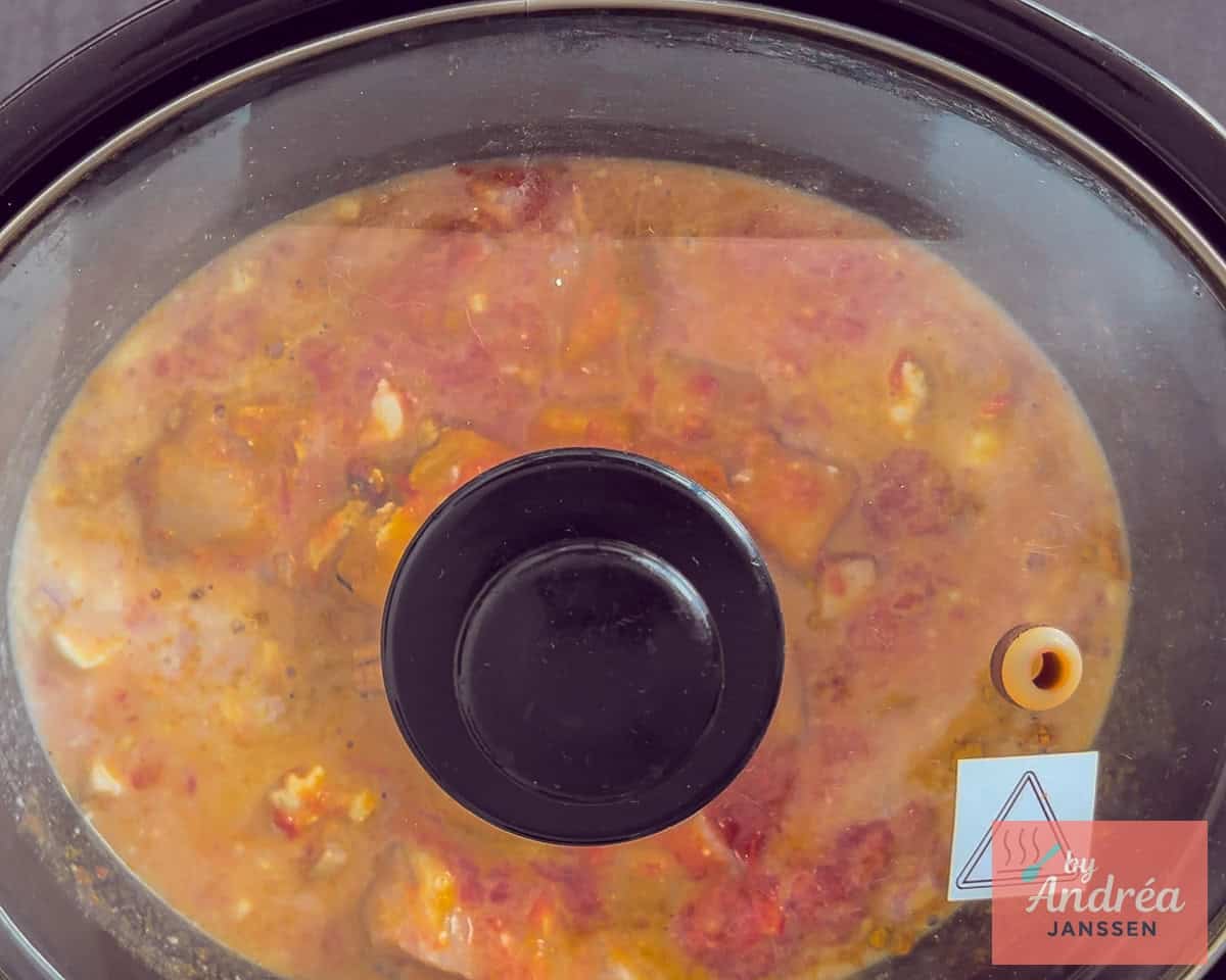 A slow cooker filled with chicken curry
