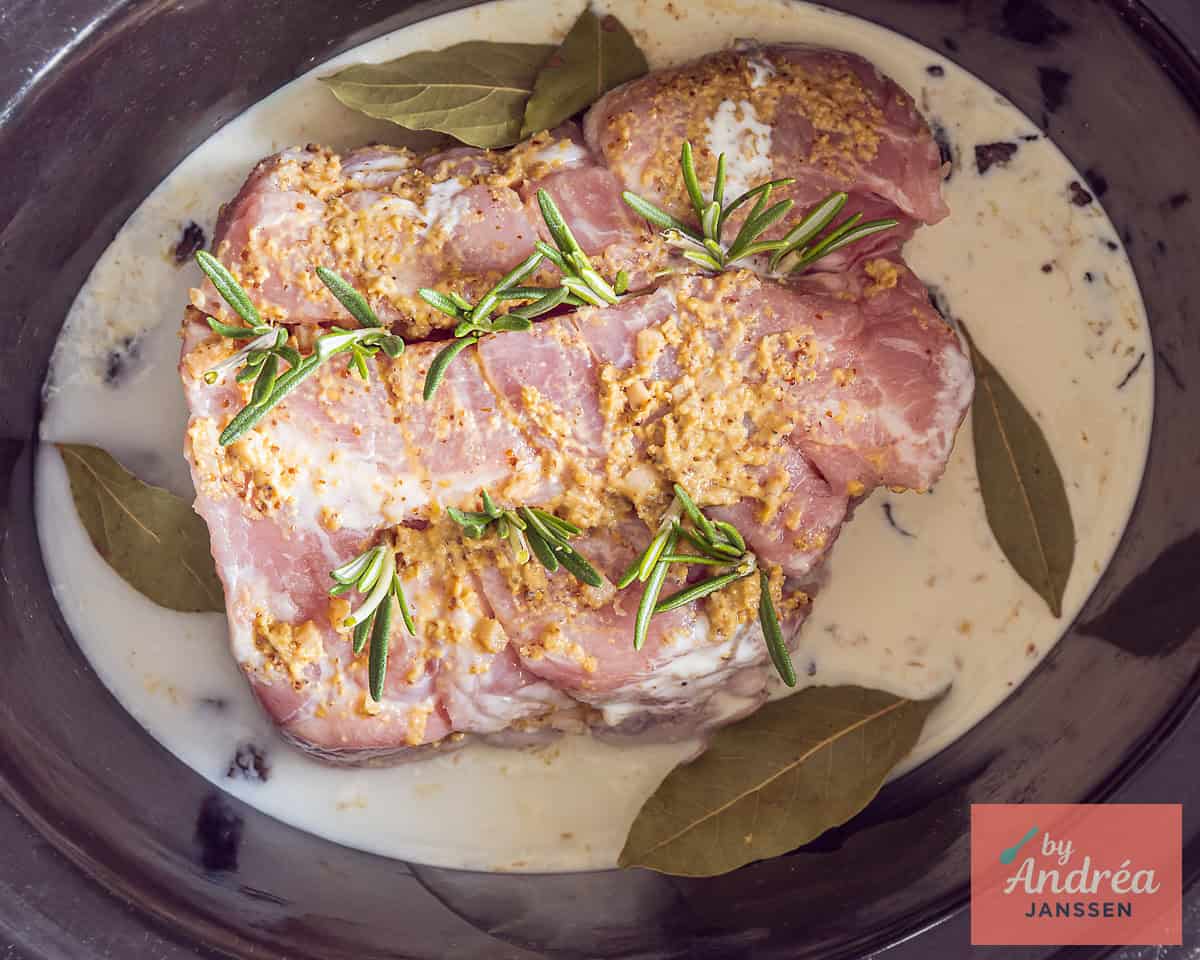 Rolled roulade with rosemary, mustard and garlic in a cream sauce with onion and seasonings in a slow cooker