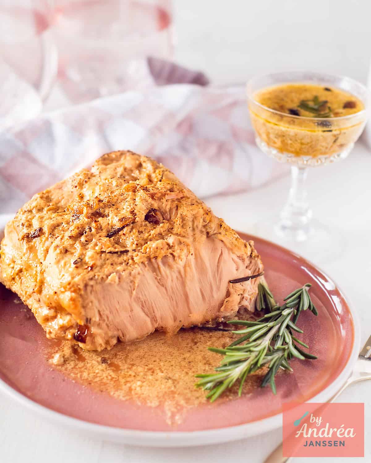 Slow cooker pork rollade with creamy onion sauce sliced on a serving platter