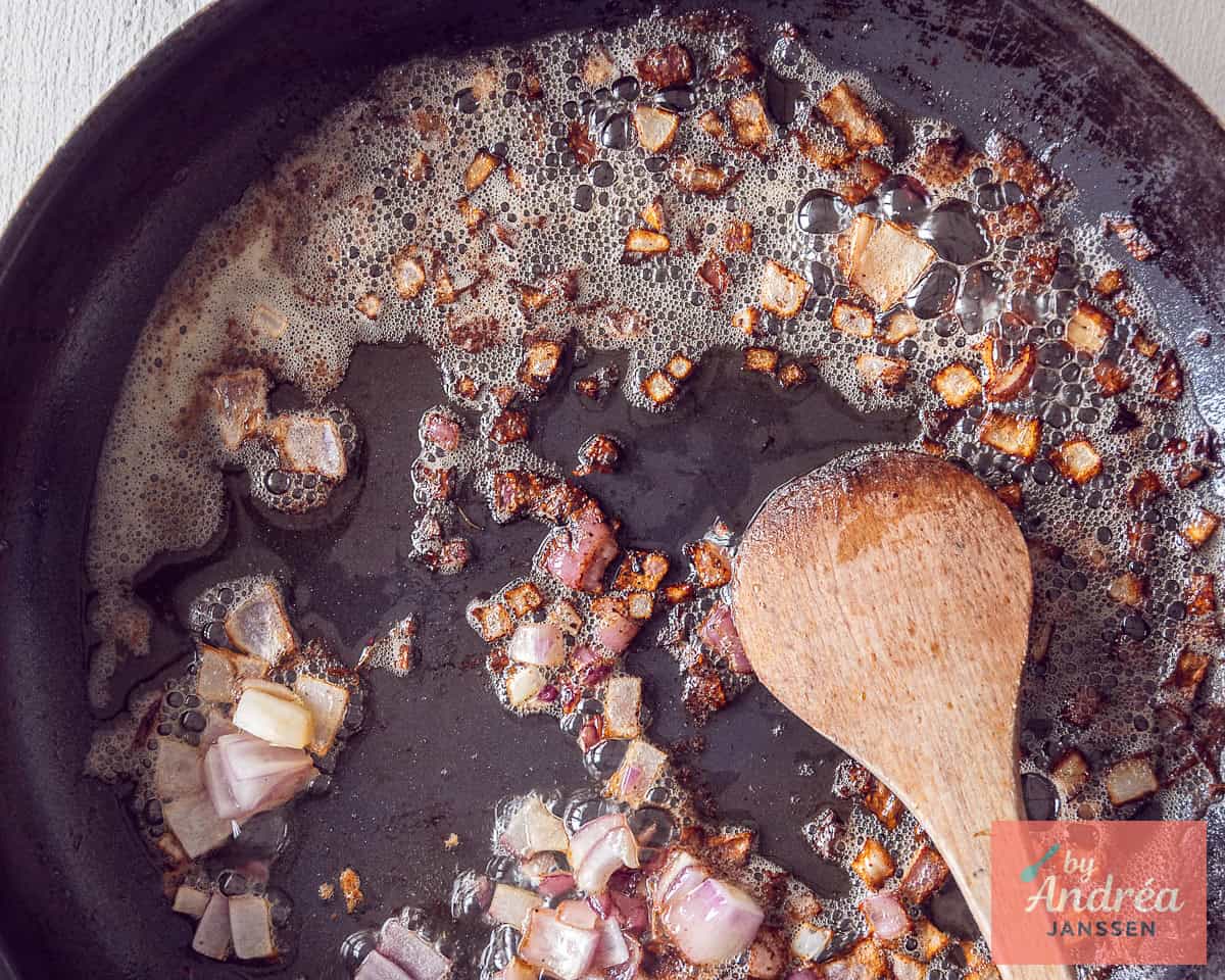 Onion is fried in the frying pan