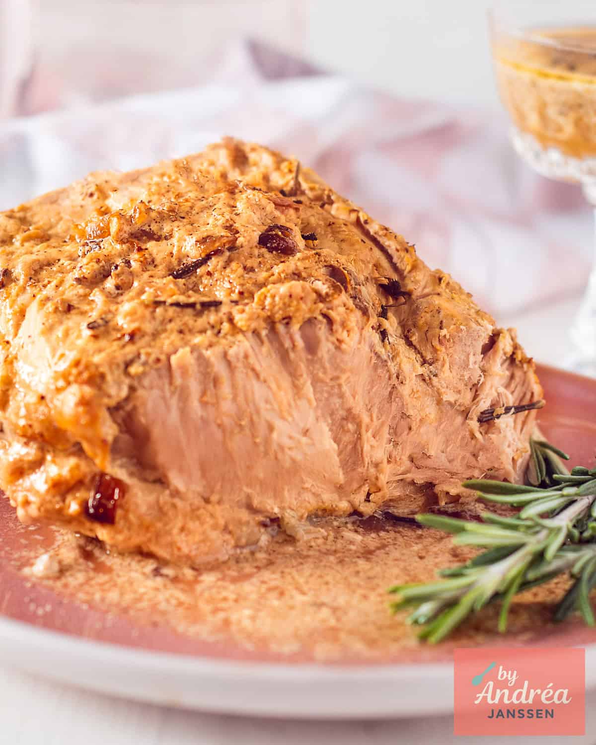 Close-up of juicy slow cooker pork rollade with mustard and garlic crust