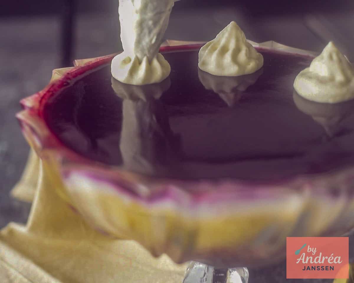Using a whipped cream piping bag, pipe large rosettes of whipped cream onto the trifle