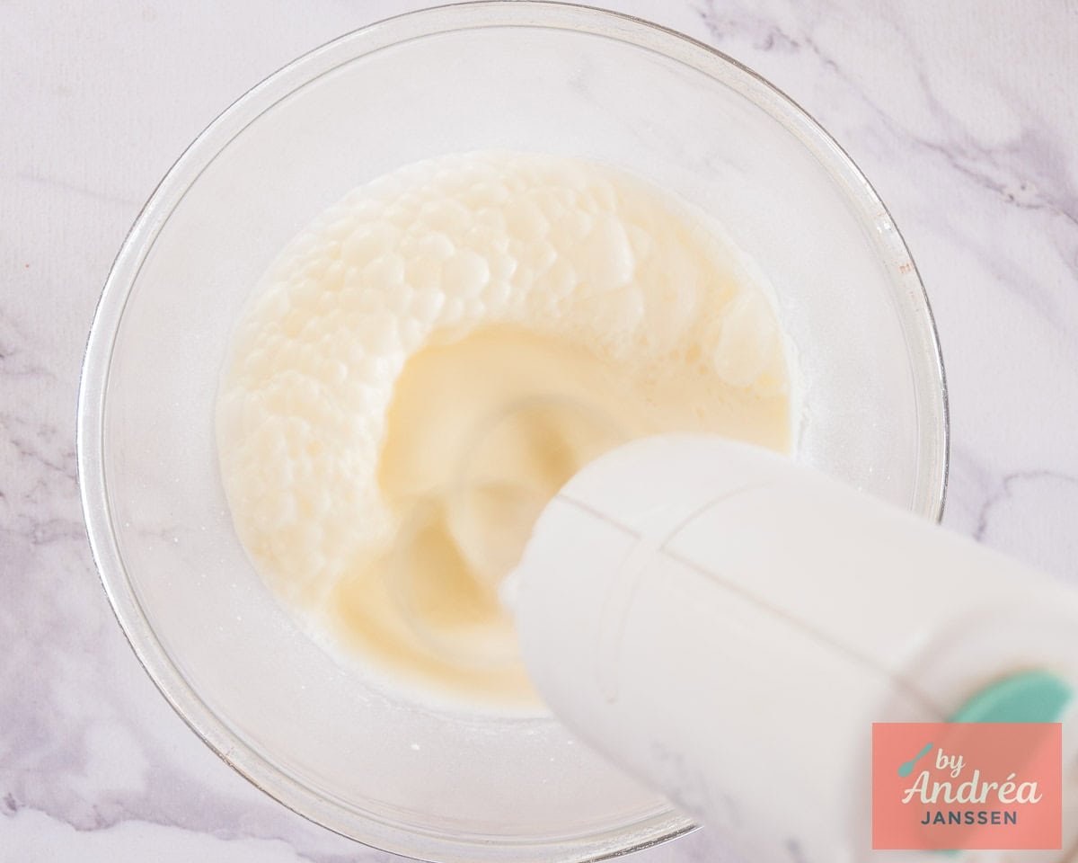 Whipping cream in a glass bowl