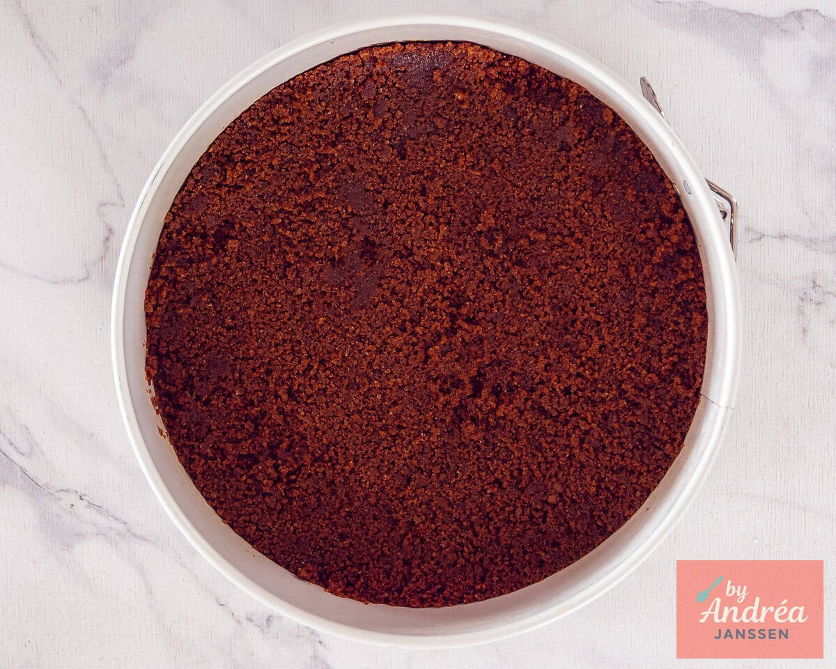 A springform pan filled with a Biscoff cookie base