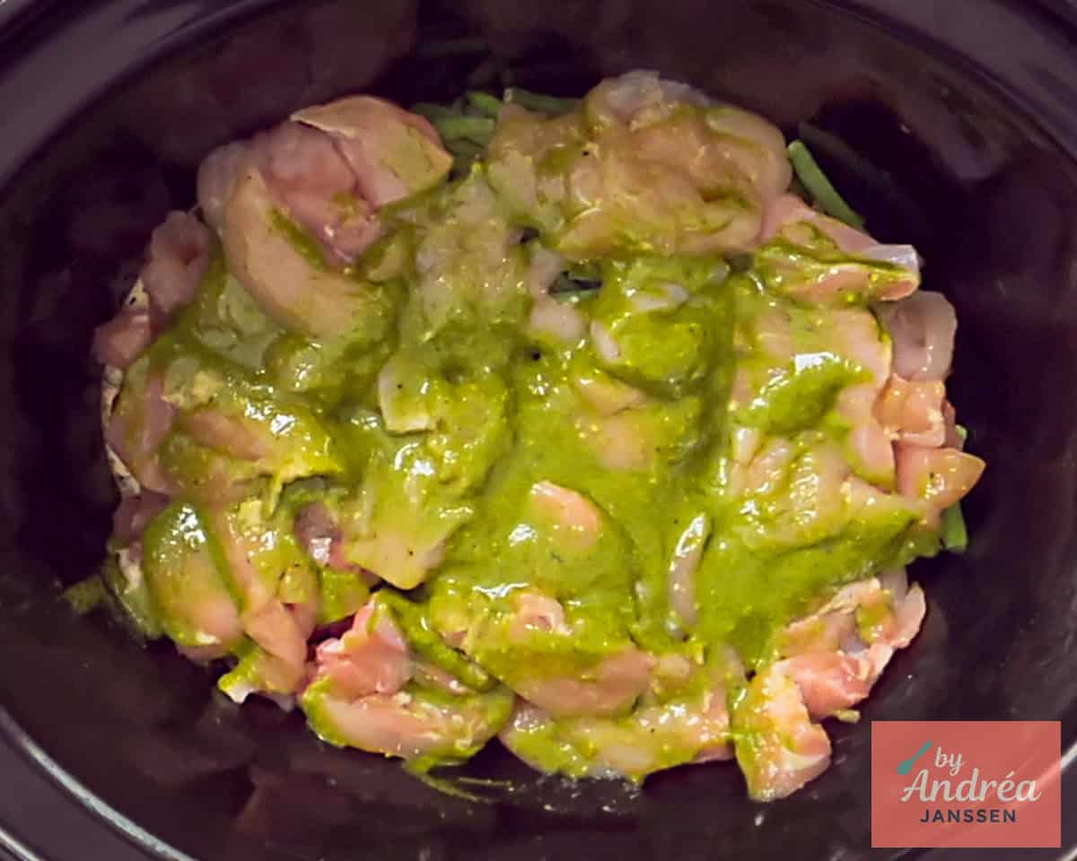 Spread pesto over the chicken in the slow cooker.