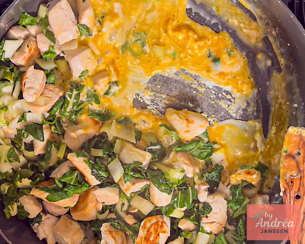 Egg added to pan with chicken and bok choy