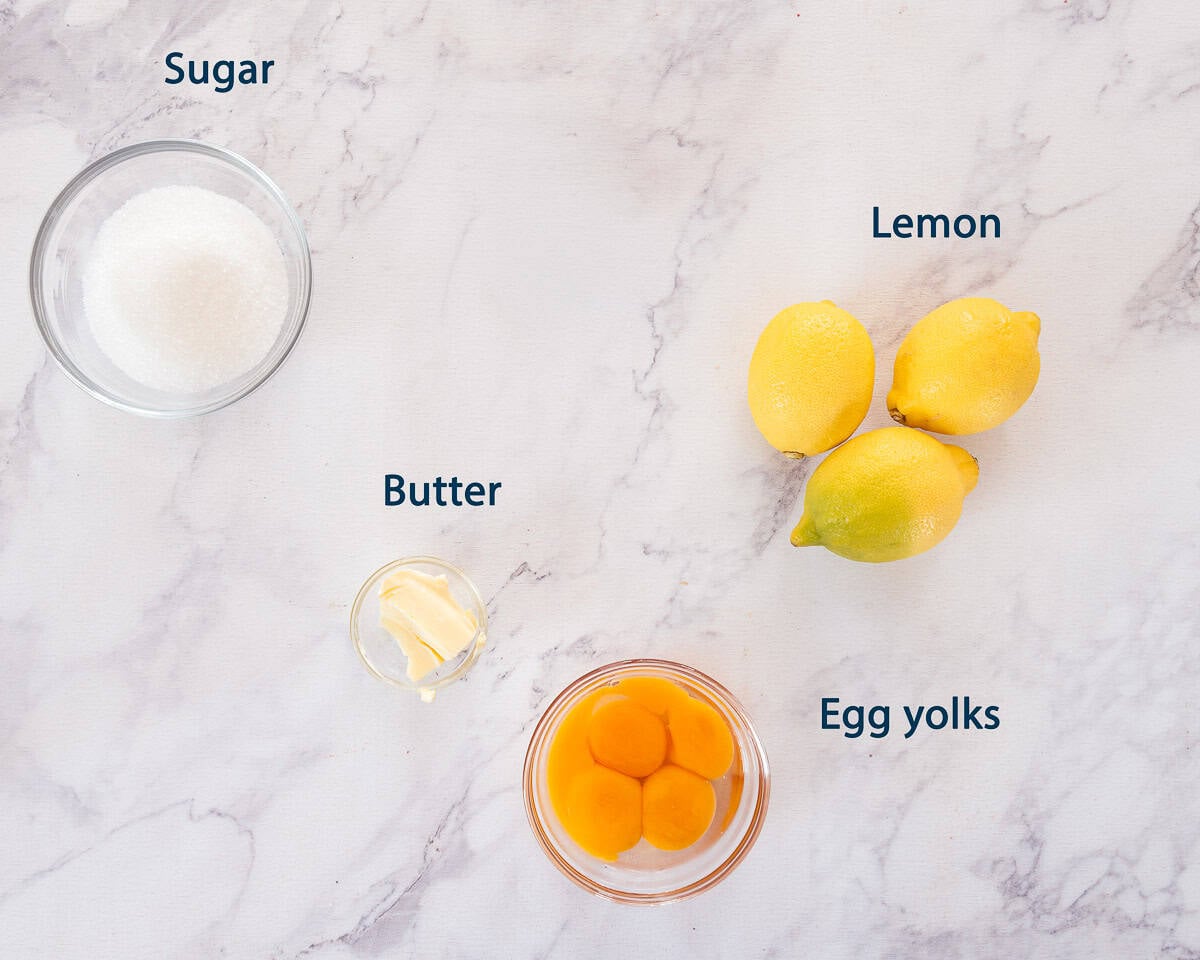 Ingredients homemade lemon curd on a white marbled background with text description