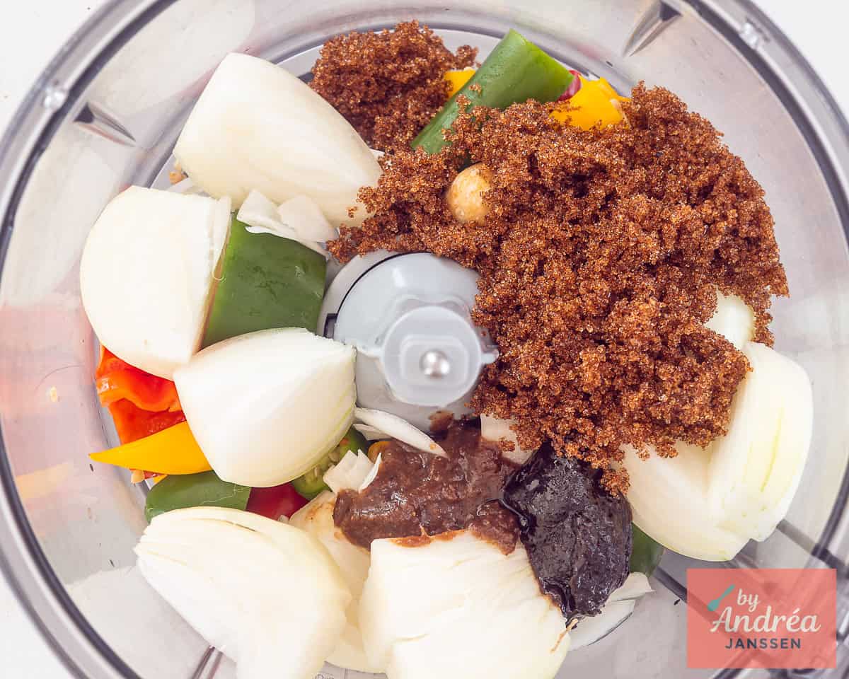 A food processor with various ingredients for sambal badjak