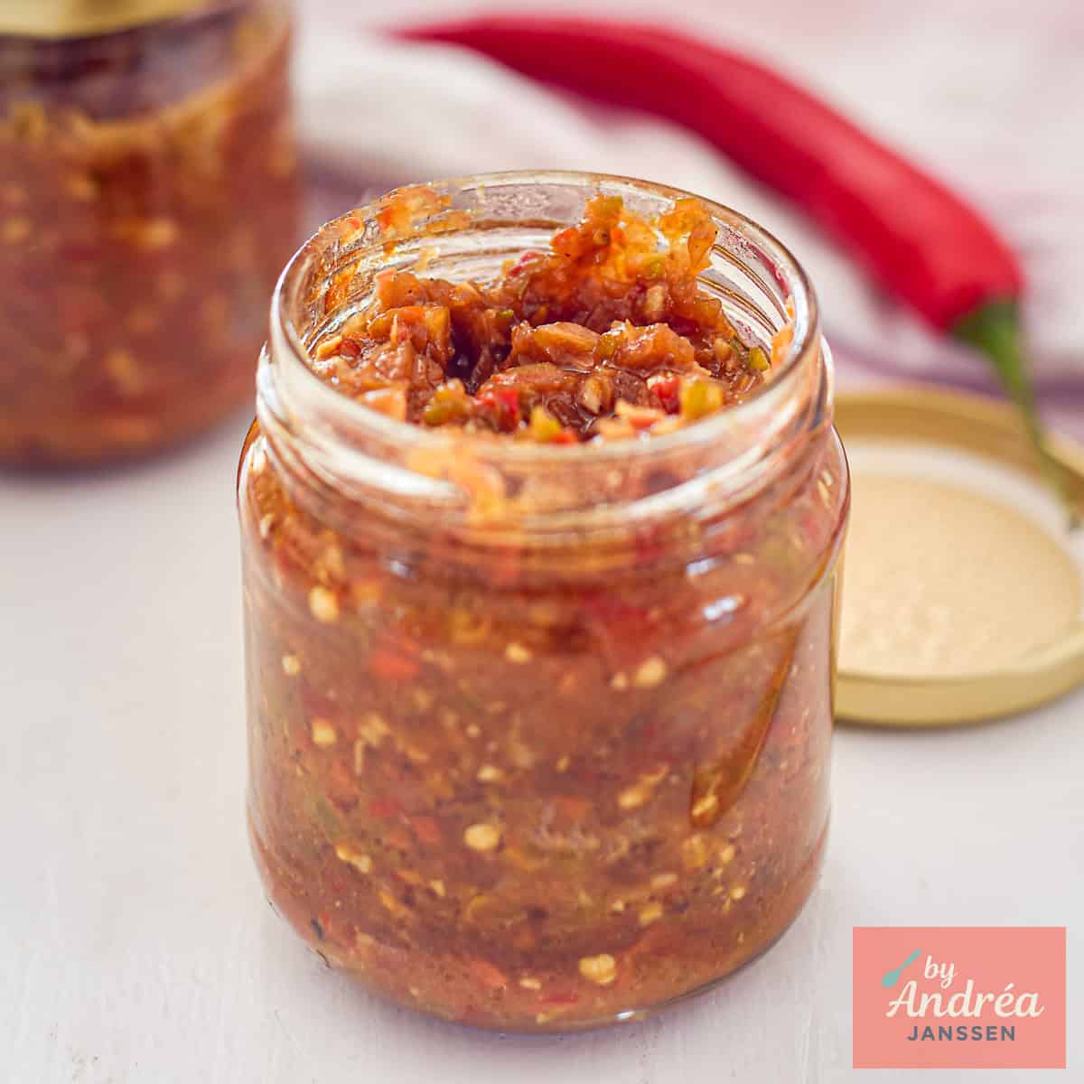 A square photo with a jar filled with sambal badjak.