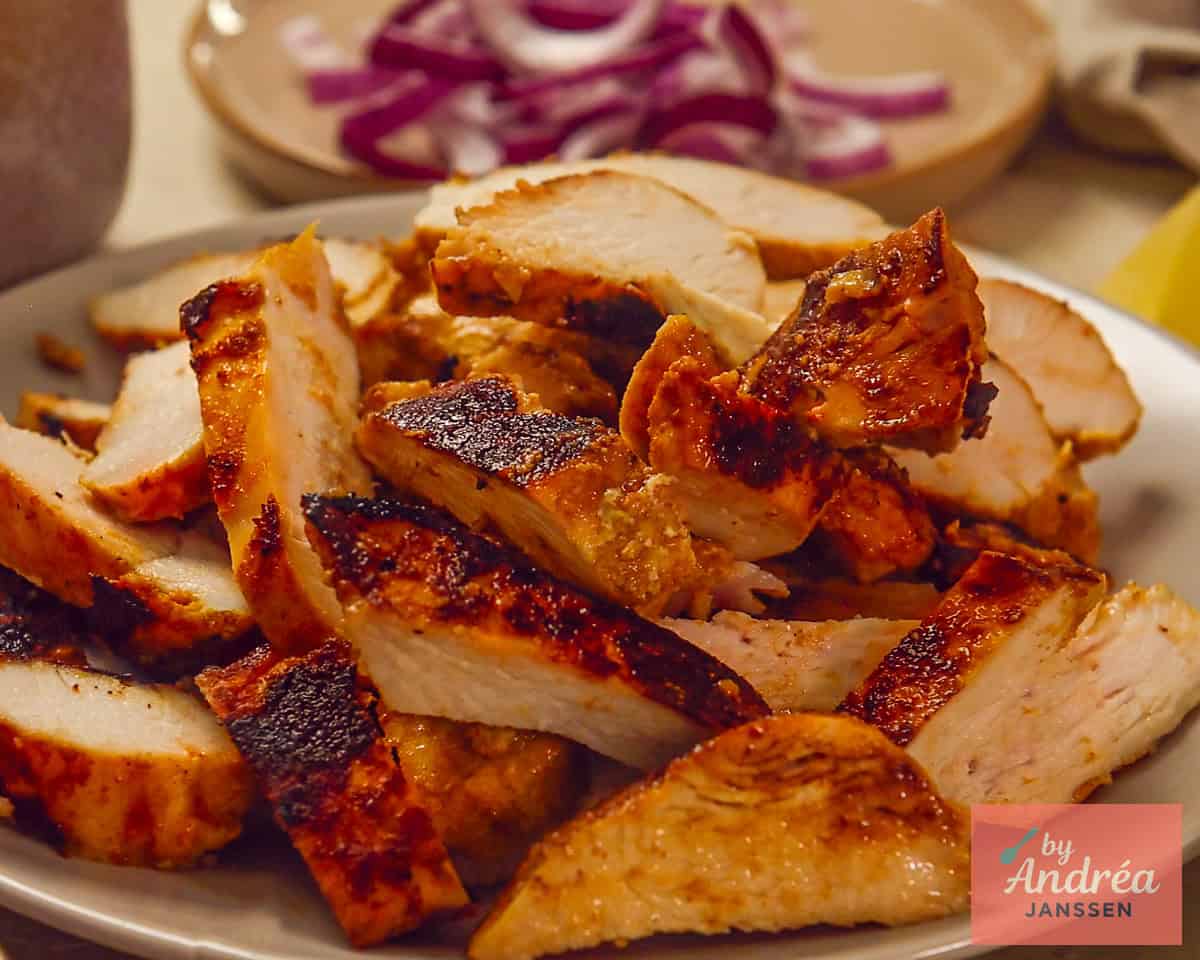 A plate with sliced chicken shawarma