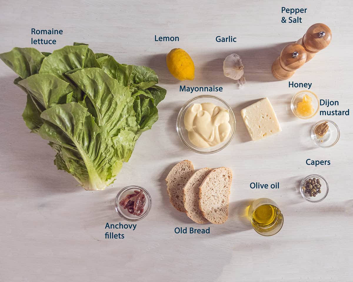 ingredients Caesar Dressing Recipe Without Raw Egg on a beige background with text description