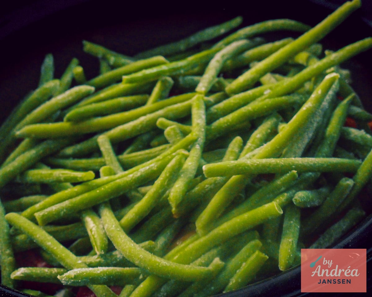 Frozen green beans added on top of the beef in the slow cooker