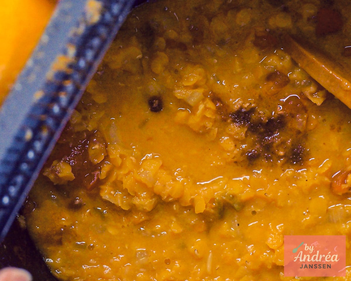 adding lemon zest to yellow split peas with spices in the slowcooker