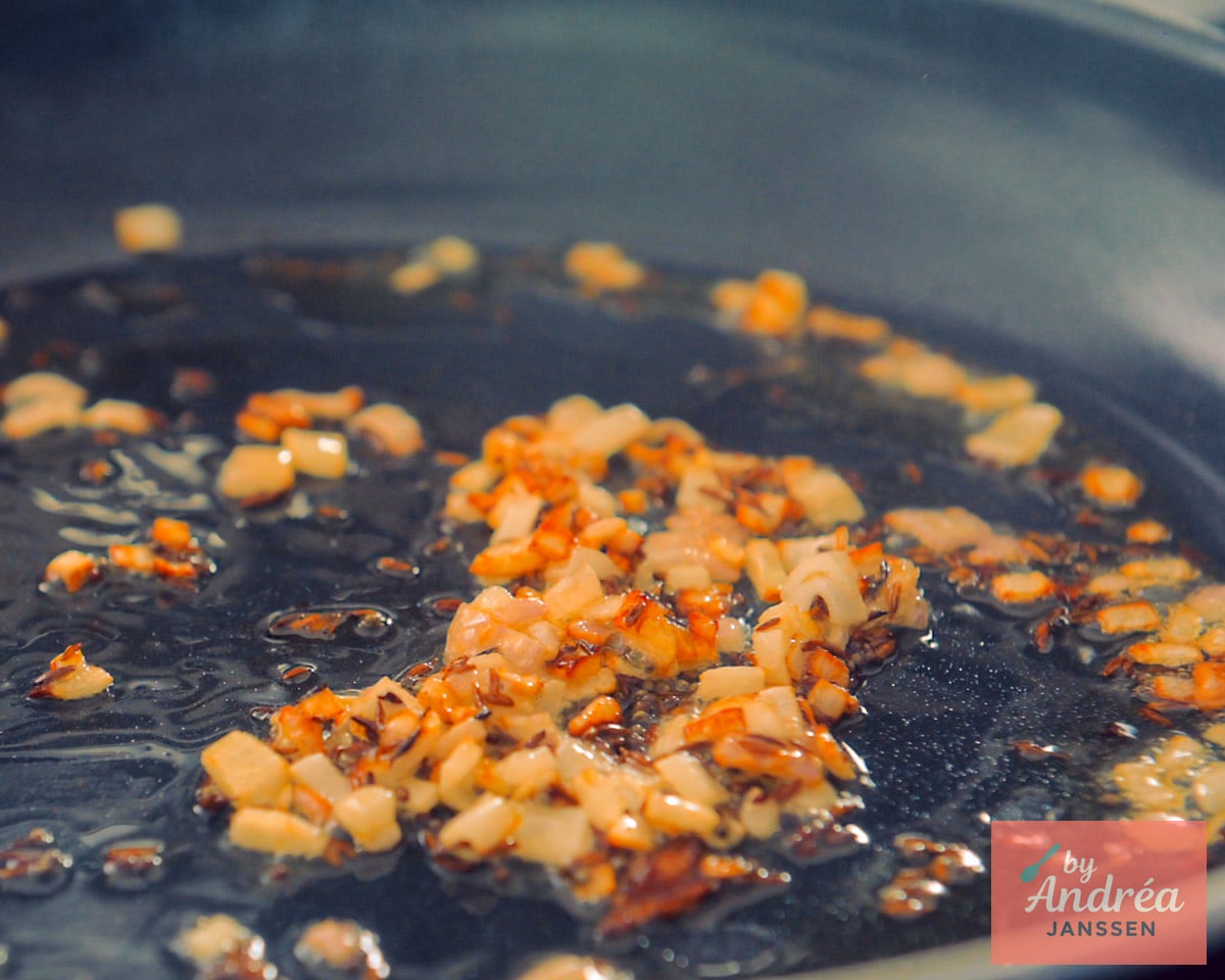 Frying onion and other spices in a skillet