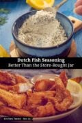 Top: a hand lifts a spoonful of pale fish seasoning speckled with green herbs from a dark blue bowl on a wooden trivet, with lemon wedges on a blue table. Bottom: a plate of golden fried kibbeling, Dutch fish nuggets, with a lemon wedge. Text on the image: Dutch Fish Seasoning – Better Than the Store-Bought Jar.
